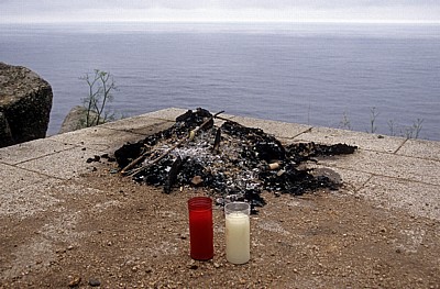 Jakobsweg (Camino a Fisterra): Ausgebrannte Feuerstelle mit zwei Kerzen - Kap Finisterre