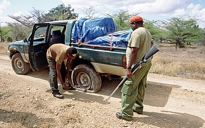 Reifenwechsel im Schutze eines bewaffneten Rangers - Selous Wildreservat